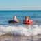 Two boys body boarding together